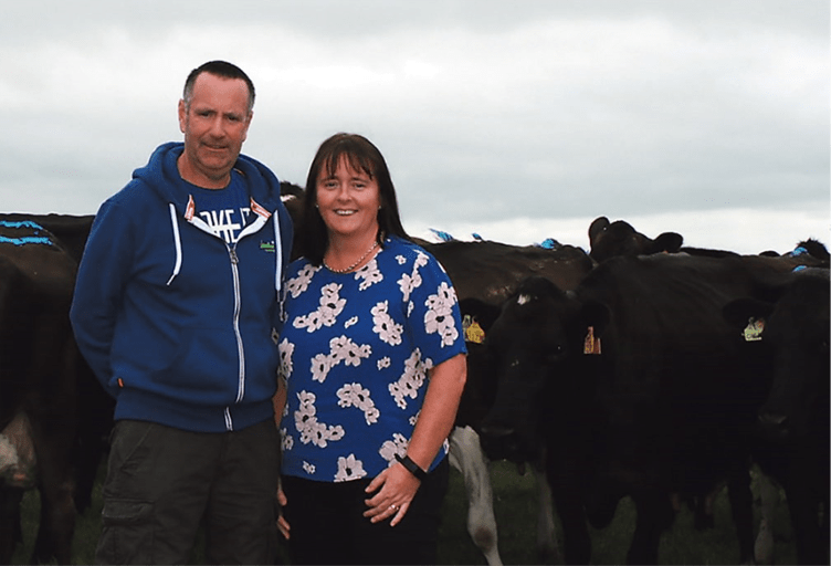 Denis and Collette O'Donovan standing in front of their dairy herd on Rouryhill Farm